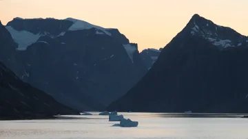 Navigating Iittuaramiit Fjord (Southern Skjoldungen Fjord) Aboard Seabourn Venture at dusk 