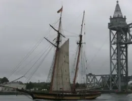 Pride of Baltimore II passes Cape Cod Railroad Bridge